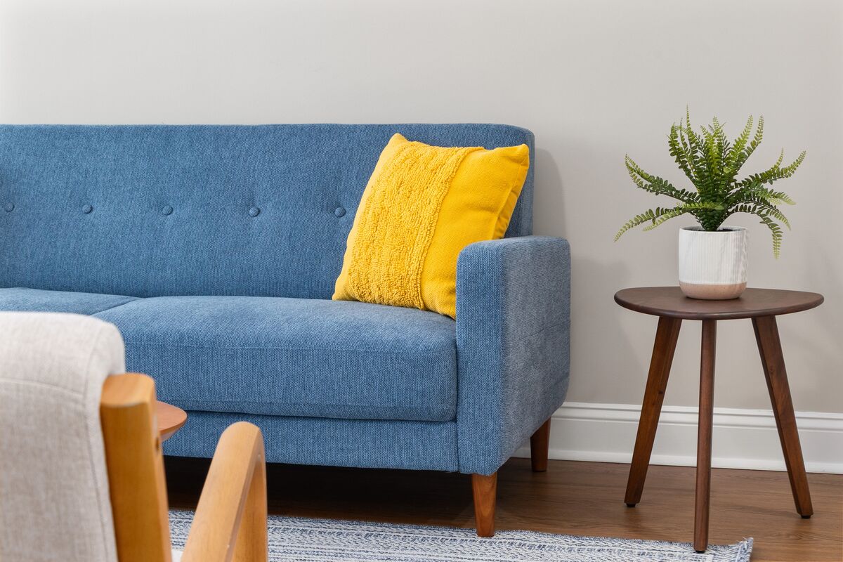 Blue sofa with yellow pillow